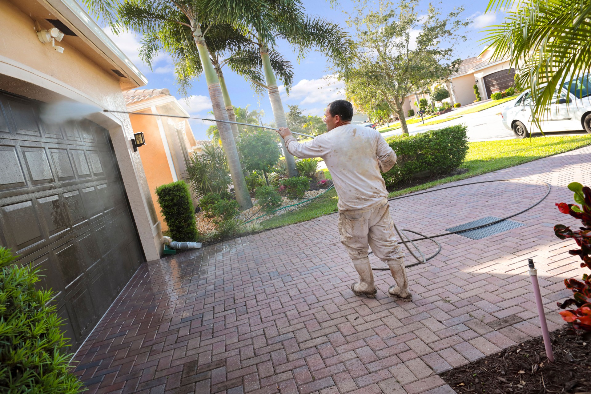 Series:Hispanic Male painter power washing an upscale home